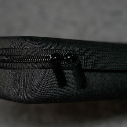 Close-up of a Akko Keyboard Carrying Case on a textured black surface