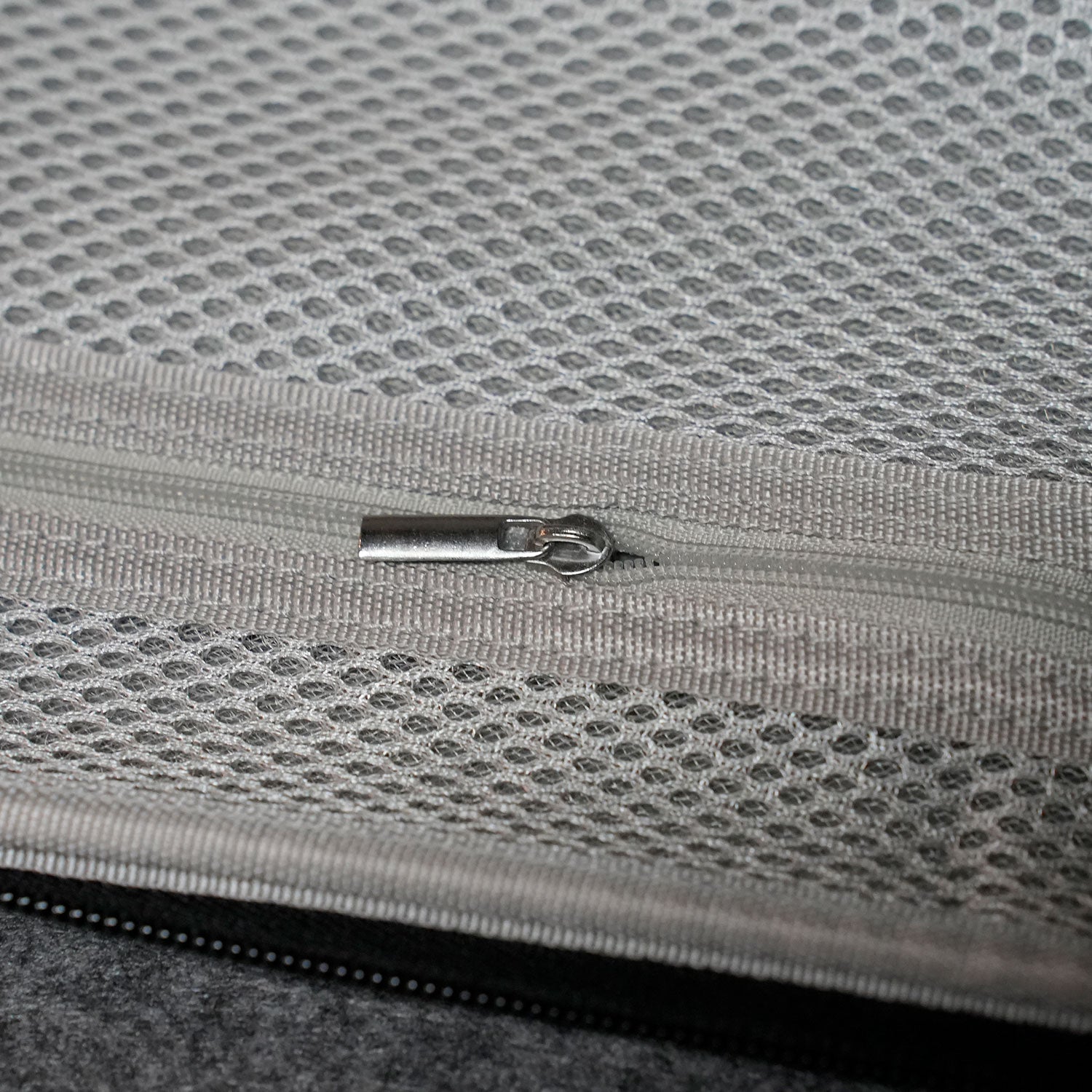 Close-up of a Akko Keyboard Carrying Case on a textured gray fabric surface