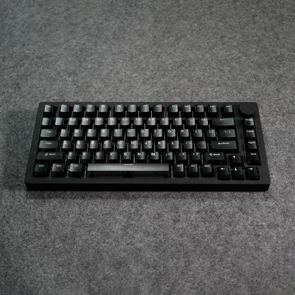 Black MonsGeek M1 V5 HE Magnetic Keyboard on a gray surface