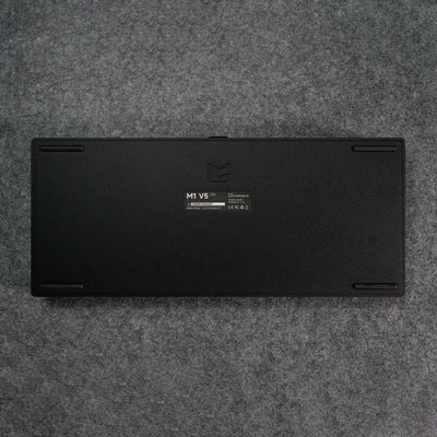 Black MonsGeek M1 V5 HE Magnetic Keyboard Back Details on a gray textured surface