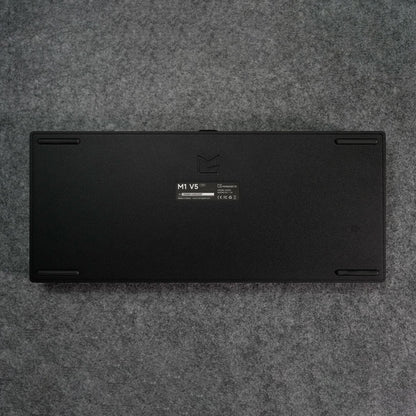 Black MonsGeek M1 V5 HE Magnetic Keyboard Back Details on a gray textured surface