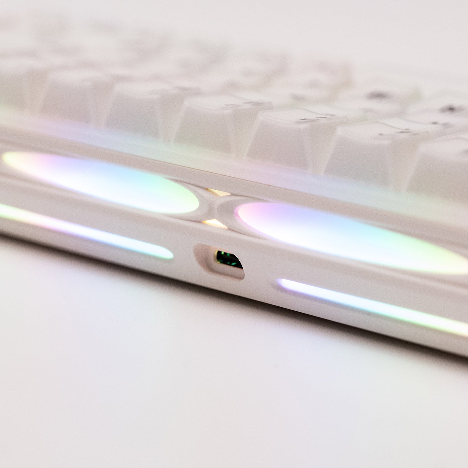 Close-up of a Verve68 HE keyboard hollow case with iridescent finish on a white background